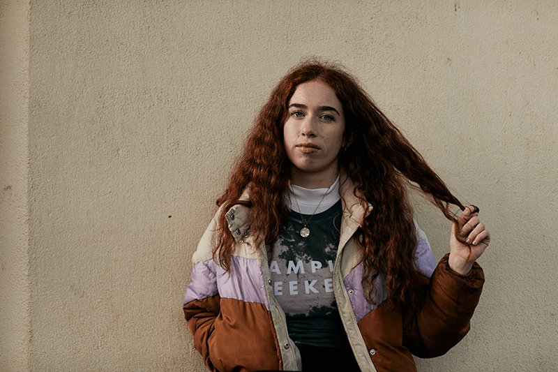 Cleo Bryne in front of a neutral background