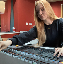 A female music student working in the Digital Composition Studio