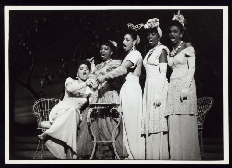 Five Black women in 1940s' costume singing