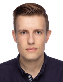 A headshot photo of Jon Rowson in front of a white background