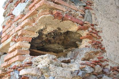 The re-use of broken tile in rough stone masonry and the post-abandonment removal of brick as spolia for re-use elsewhere