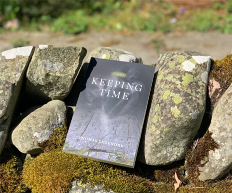 Book, with the title 'Keeping Time' rested on a mossy drystone wall.