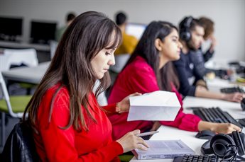 A row of students studying in the computer room