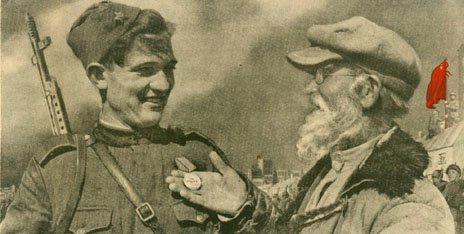 Older man admiring the medal on a young soldiers uniform