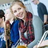 female-student-smiling-with-instrument