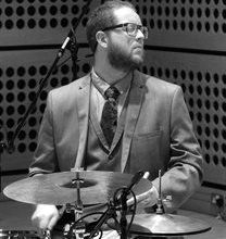 Black and white image of Andrew Wood playing the drums