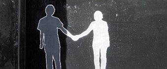 black and white street art of two people holding hands