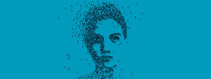 Blue image with a person's face created by people standing in a pattern as seen from above