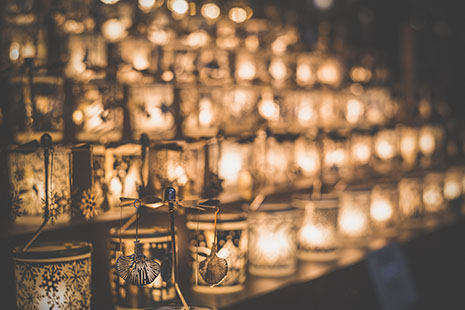 Rows of candles in patterned holders