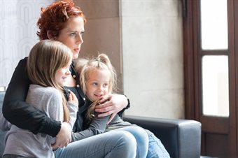 Lisa cuddling with her two children cuddl