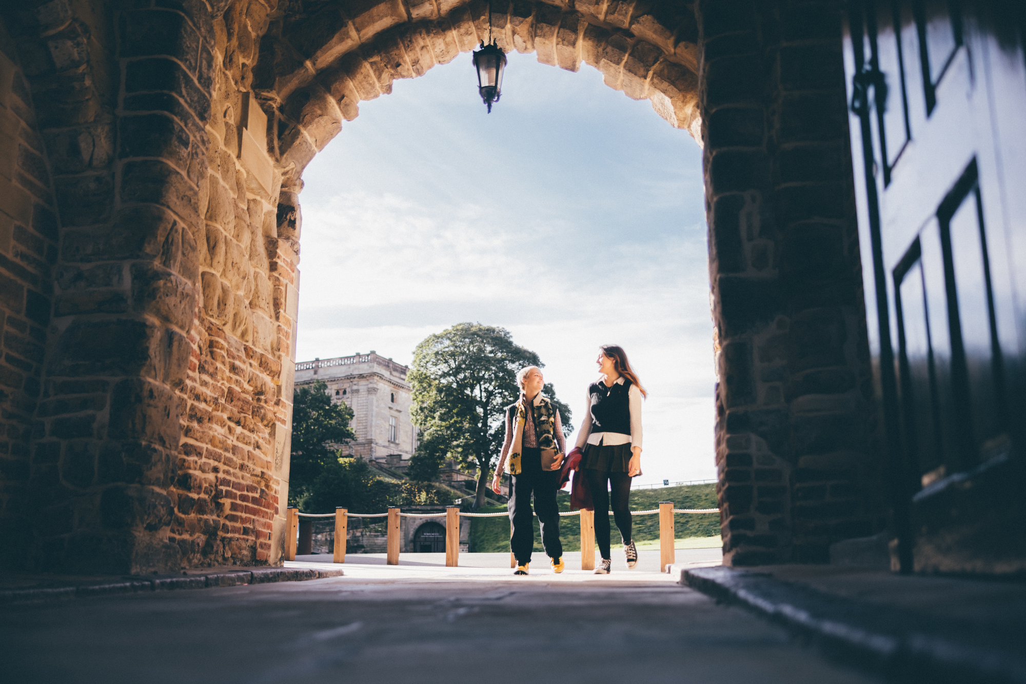 Two students walking through the entrance of Nottingham castle