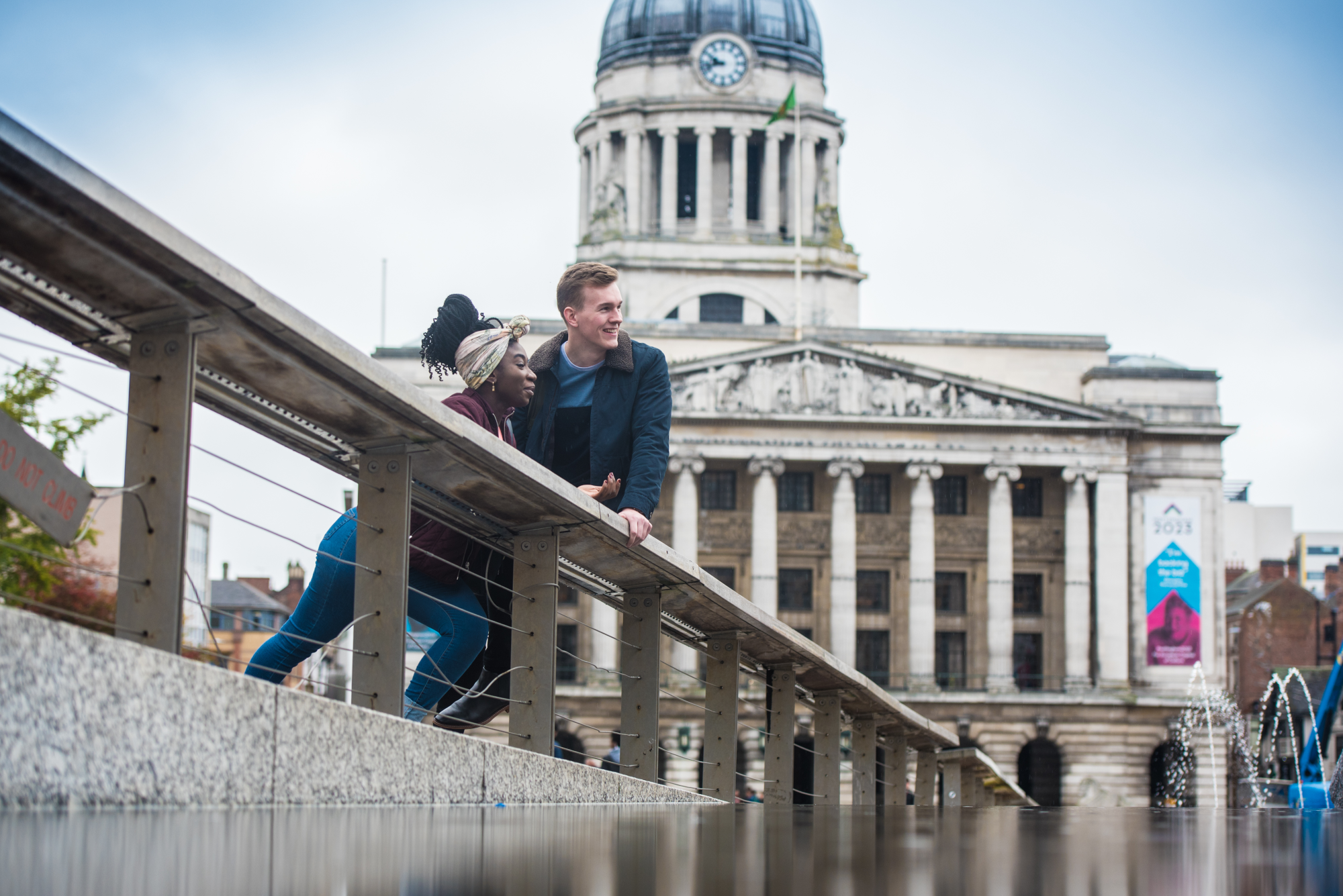 Two students standing by fountain in Old Market Square, Nottingham