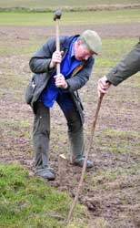Photograph of the Bailiff of the manor hammering in a boundary stake, 2008