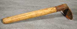 Wooden-handled scraper for removing pig bristles