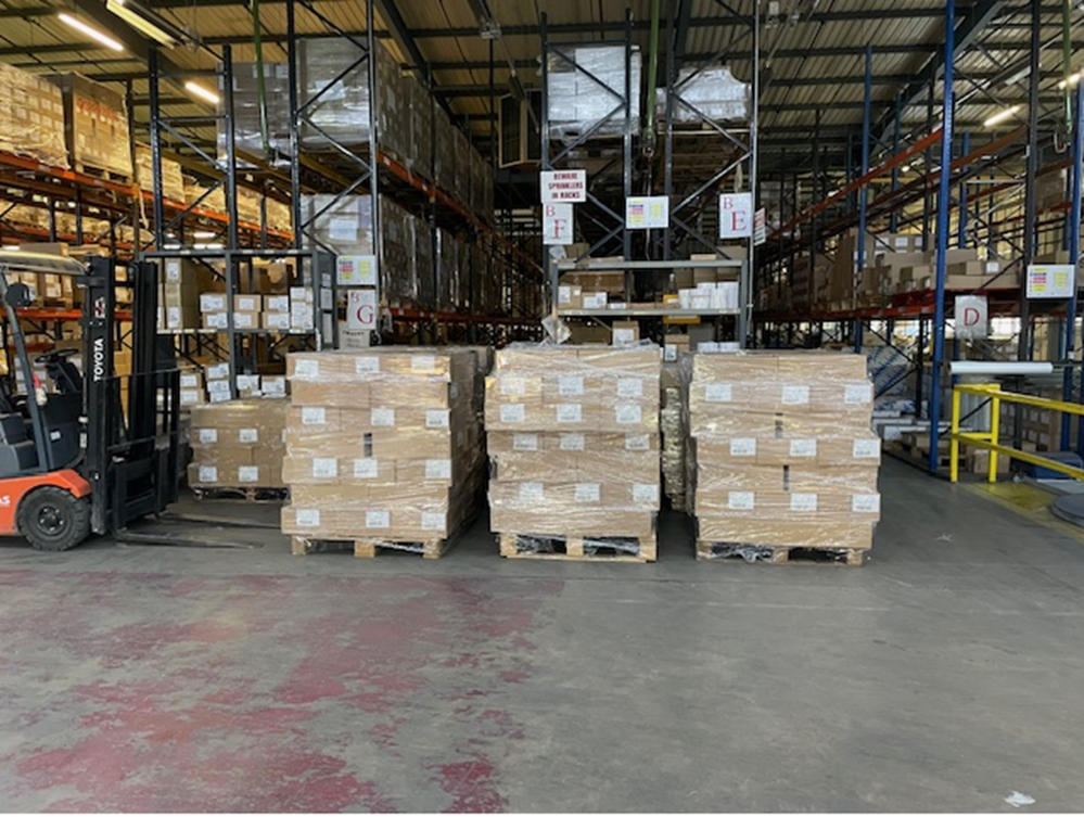 Boxes of pupil surveys loaded on a wooden pallet.