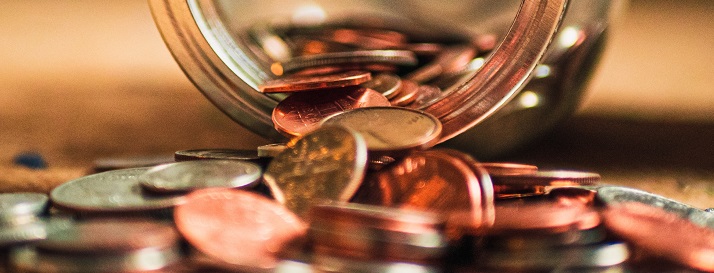 Coins tumbling from a glass