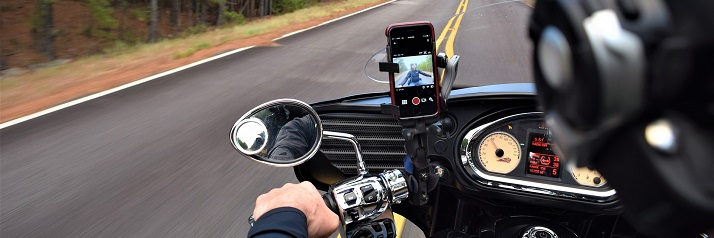 Motorcycle on country road using smart phone