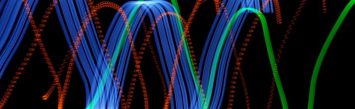 different coloured light waves on a black background