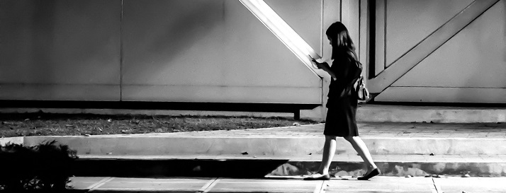 Female walking alone on dark road