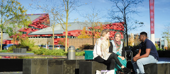 Male and female undergraduate students relaxing on Jubilee Campus