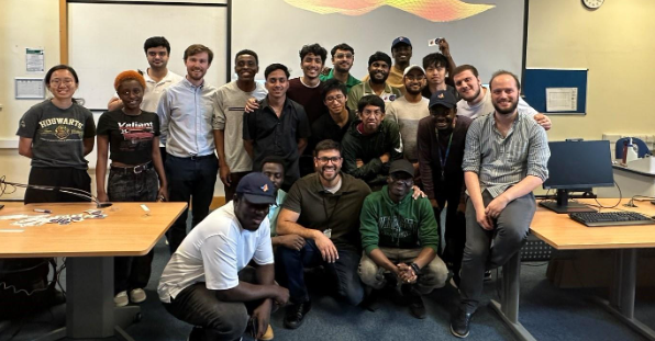 group of students together in a classroom smiling at the camera