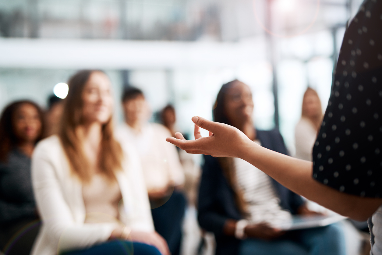women speaking at a conference