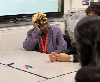 Afro-Caribbean Elder female (“Grandma” ) speaking to school children