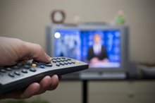 A remote control pointed at a television