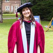 Dr Raluca Nicoras in graduation cap and gown