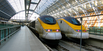 Two trains waiting in a station