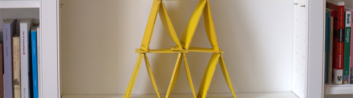 Pyramid of yellow pamphlets in bookcase shelf