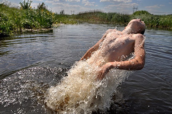 boy swimming in a river