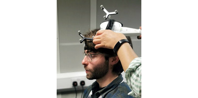 Three metal spheres (trackers) attached to the TMS coil and participants head