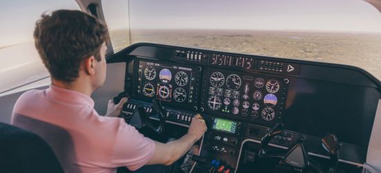 Undergraduate student piloting the flight simulator in engineering labs
