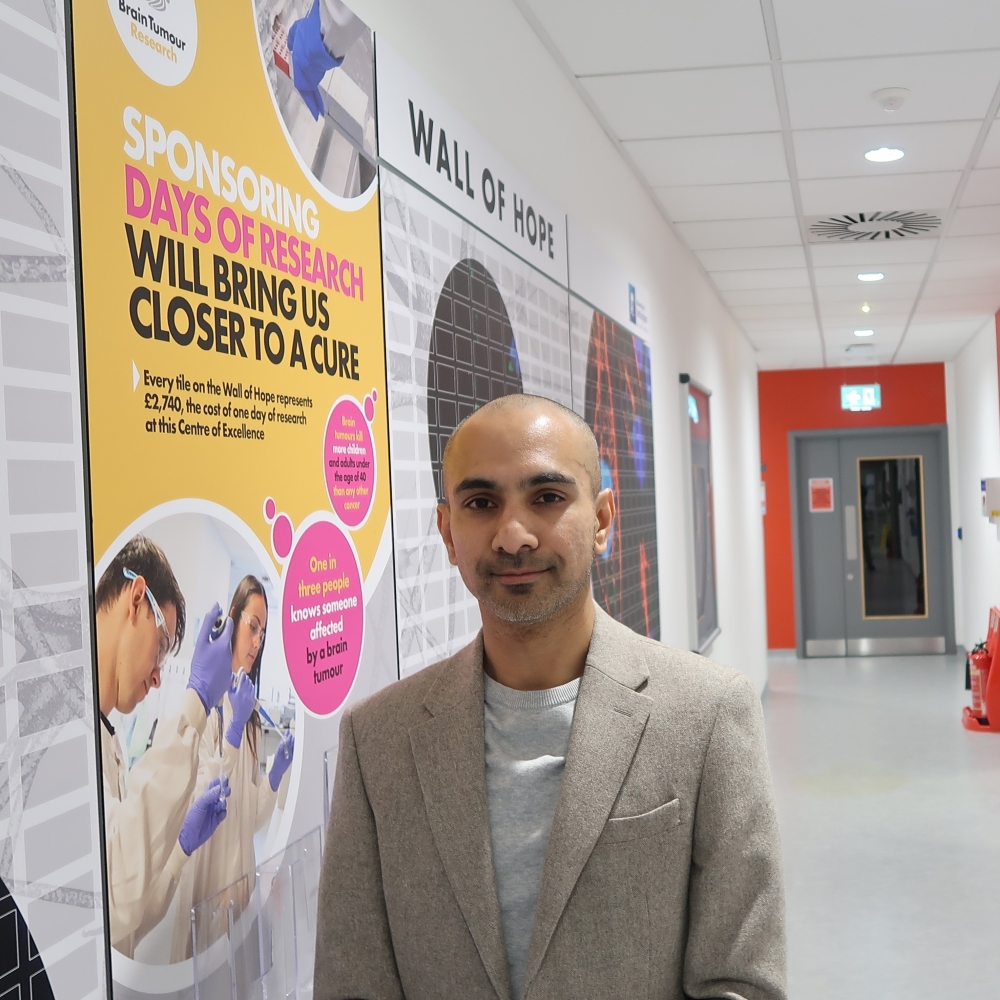 Professor Ruman Rahman next to the wall of hope