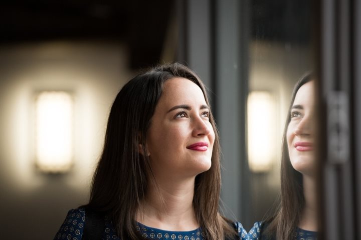 female student looking upward with smile