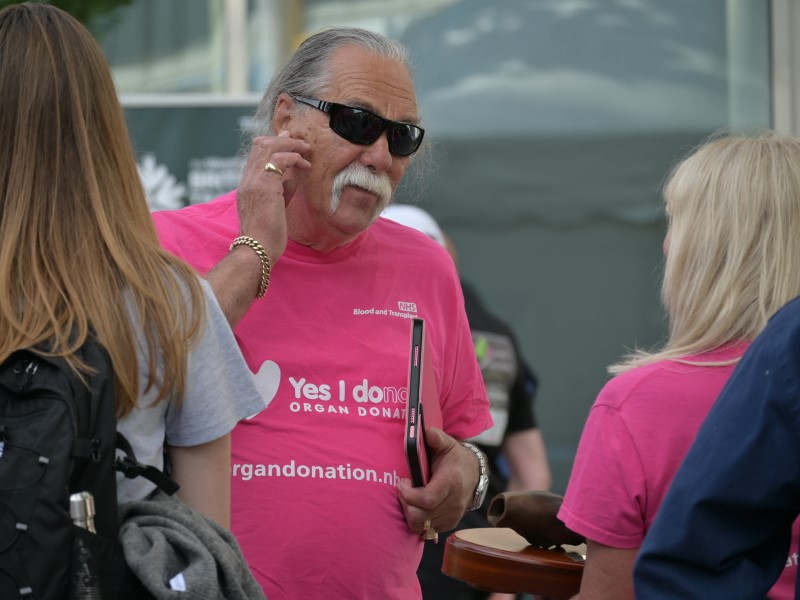 Man chatting wearing pink Organ donation T-shirt