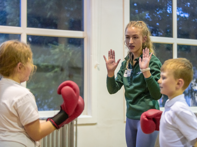 Student teaches children boxing 