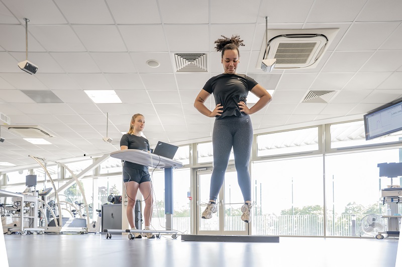 Student on laptop watched female jump in clinic