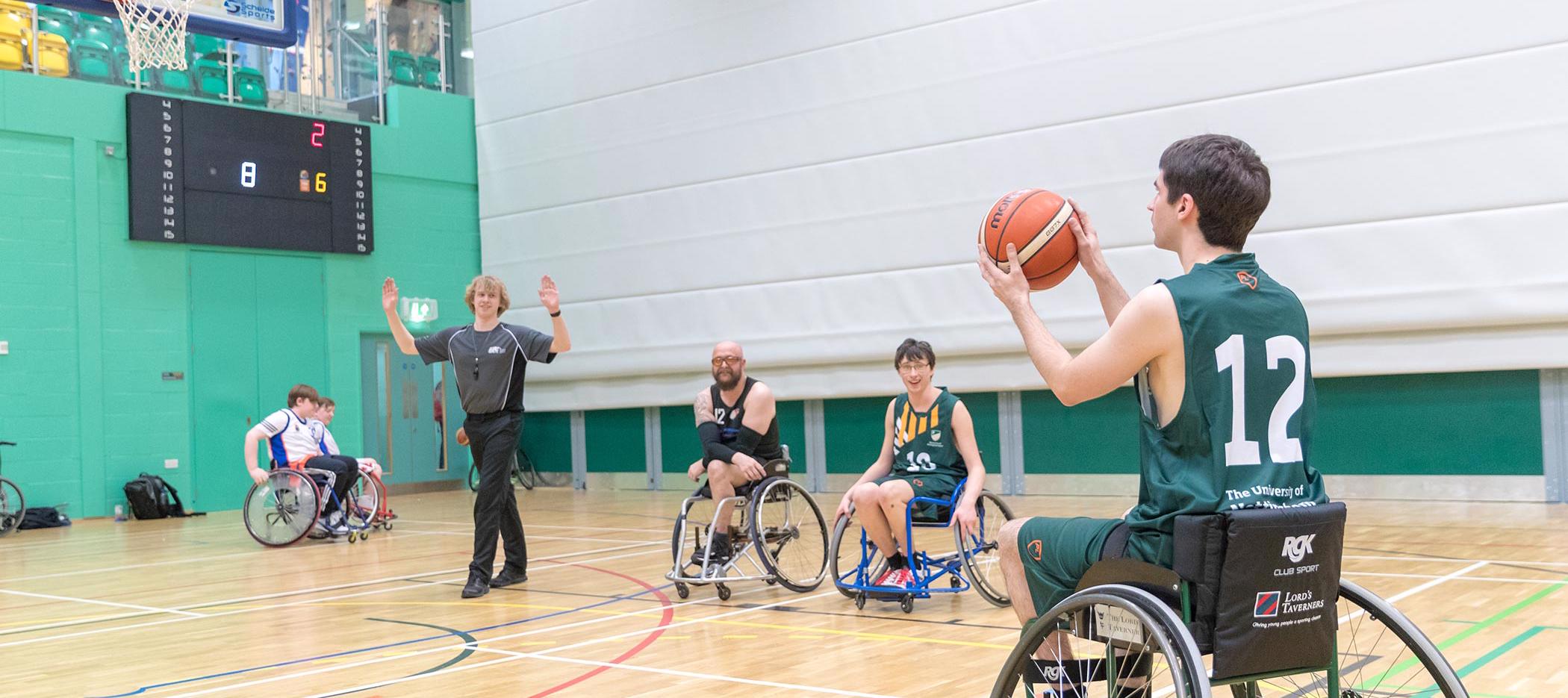 A wheelchair basketball player about to take a shot at the University of Nottingham