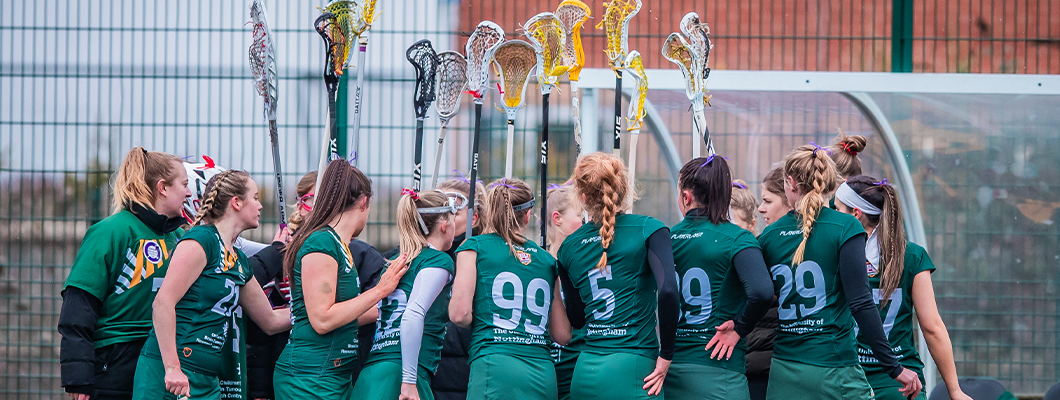 Female lacrosse players in team huddle