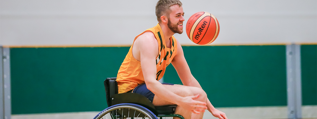 Male student playing wheelchair basketball