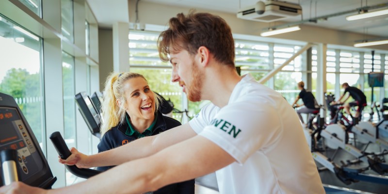 Inclusive fitness instructor works with student at David Ross Sports Village fitness suite