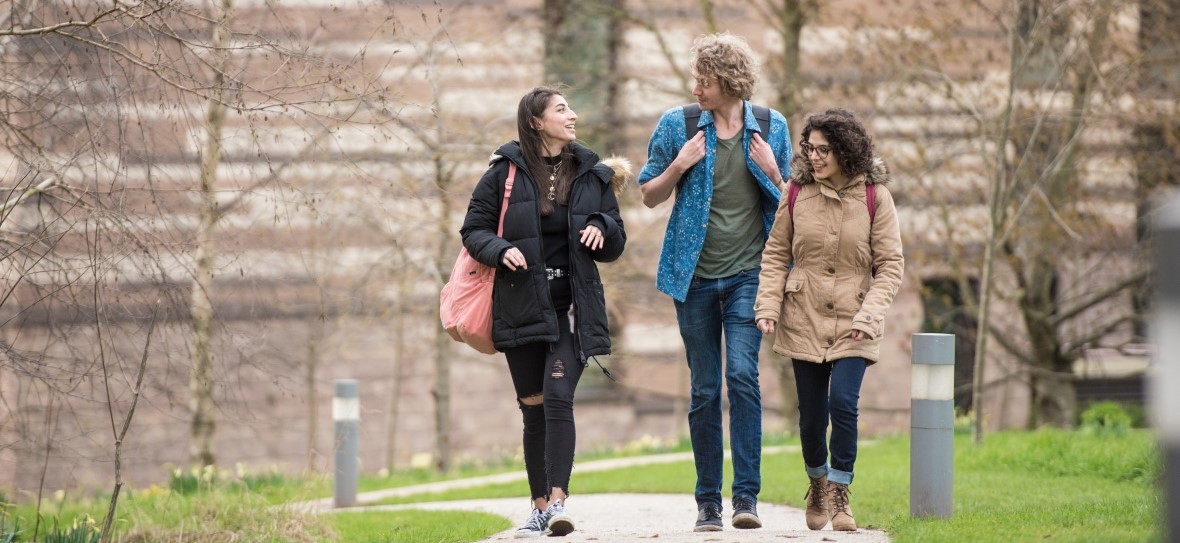 Postgraduate students walking past the Orchard Hotel, University Park