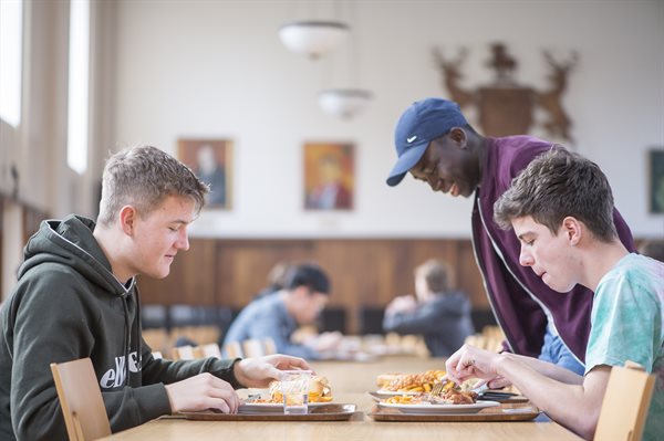 Students eating in Derby Hall Cafe situated in Derby Hall accommodation, University Park Campus