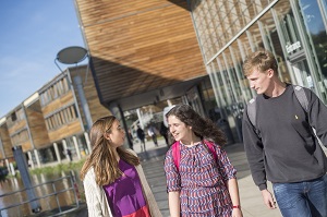 Undergraduate students walking by The Exchange building, Jubilee Campus