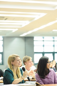 Female postgraduate student talking during a Business School lecture