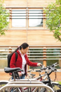 Student parking a bike on Jubilee Campus