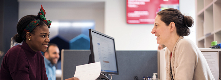 An undergraduate student being helped by a member of staff in one of our student service centres.