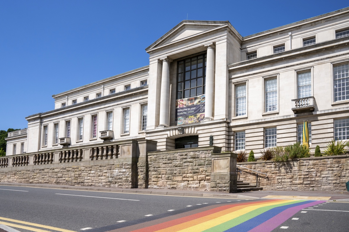 The Portland Building at University Park with an LGBT+ Pride rainbow pattern pedestrian crossing in front